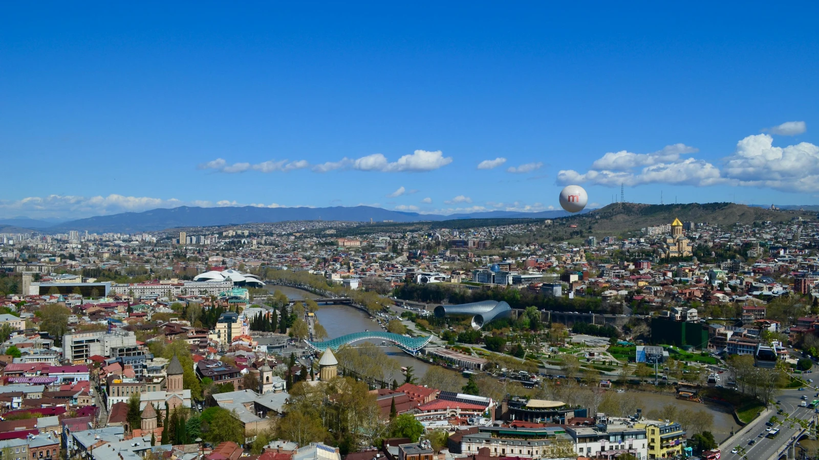 Aerial view of Tbilisi Bridge of Peace over the Kura River - car rental guide