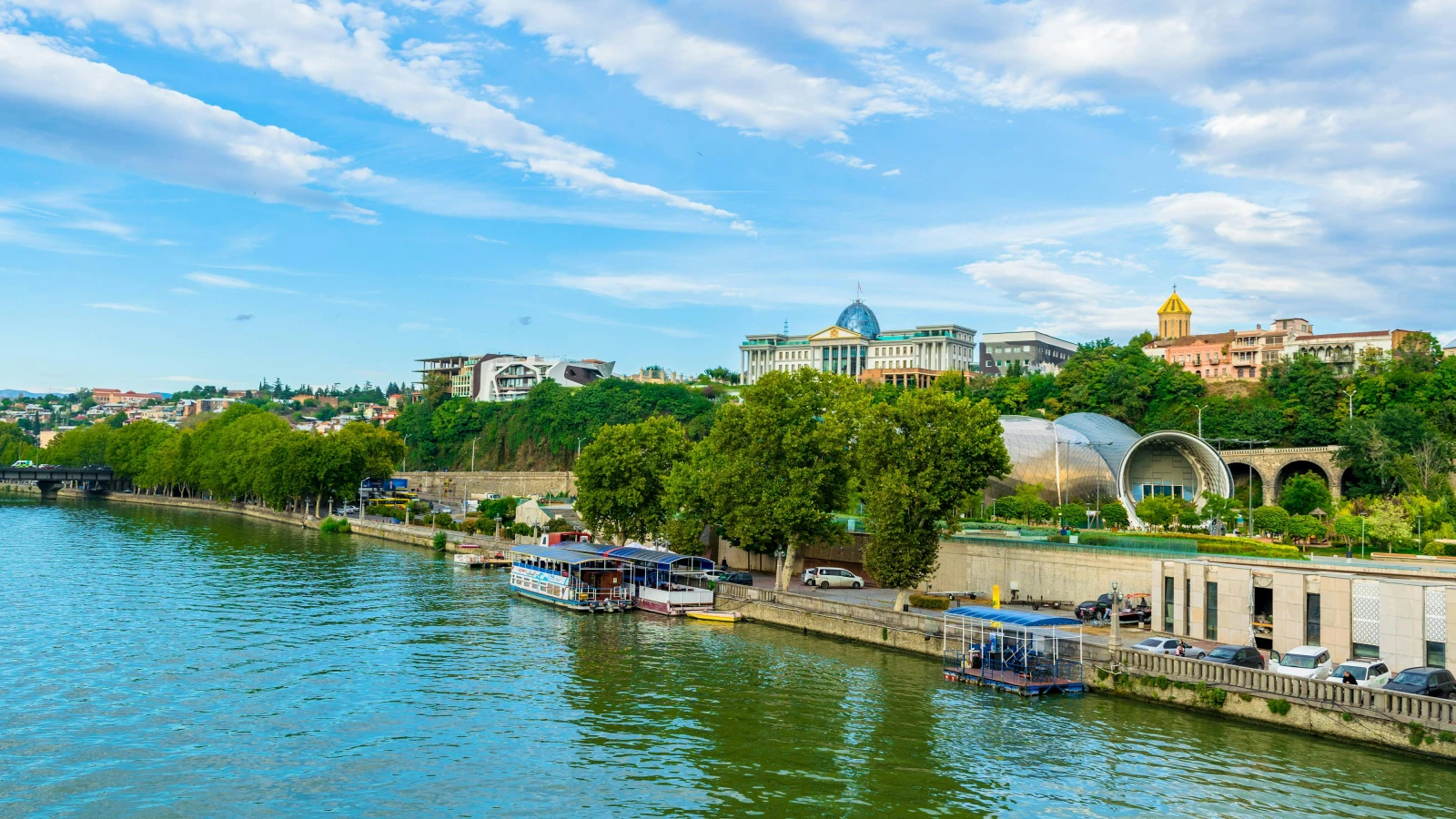 Car rental near Tbilisi Liberty Square with riverside city view