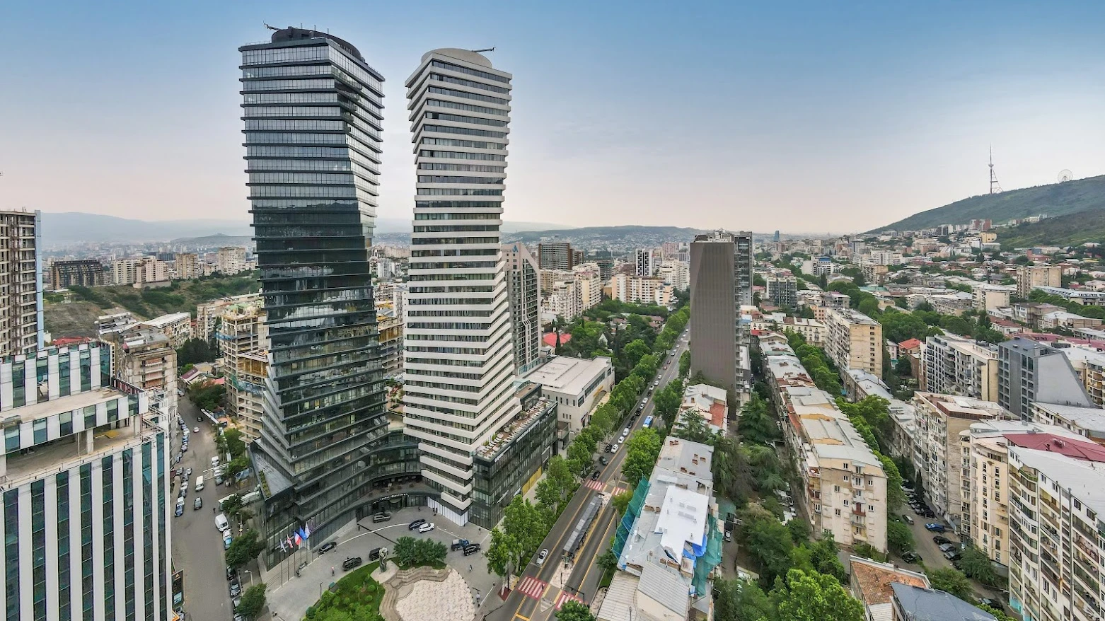Scenic car rental route through Tbilisi streets with mountain backdrop